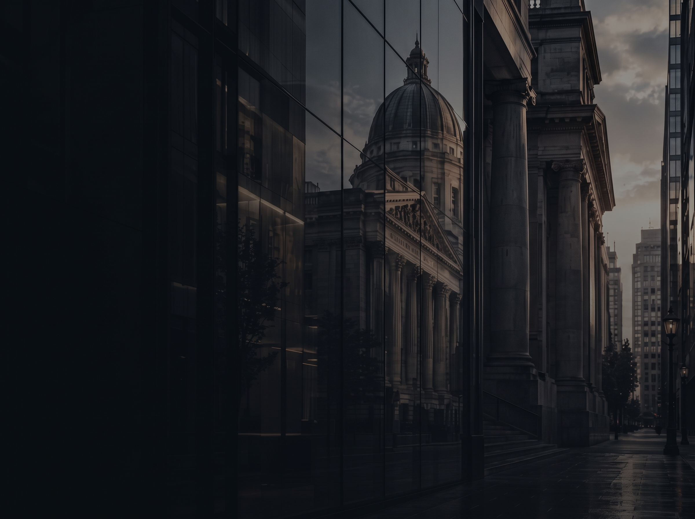 A court building reflected in glass at dusk